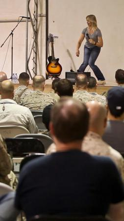 Lang Parker, comedian and fitness instructor, performs at the Town Hall, during the Armed with Laughter: Soul-dier Boot Camp Comedy Tour aboard Camp Leatherneck, Afghanistan, Sept. 23. Armed with Laughter was organized by Armed Forces Entertainment, which brought together four comedians who also taught different fitness courses.